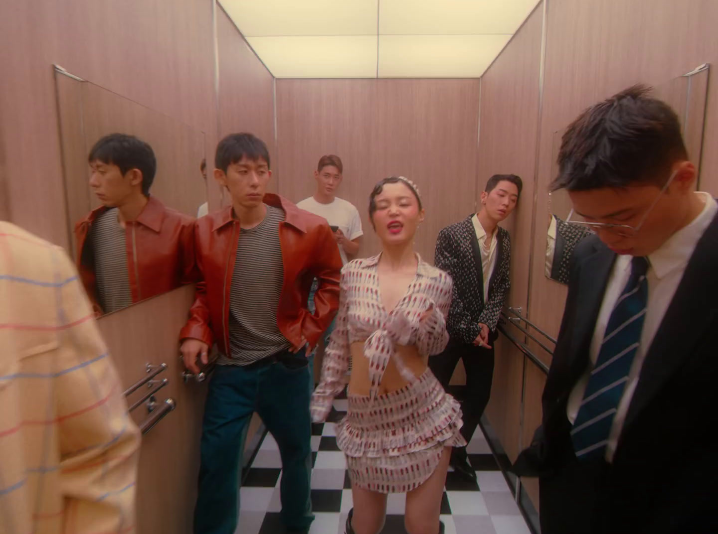 a group of people standing in a bathroom next to each other