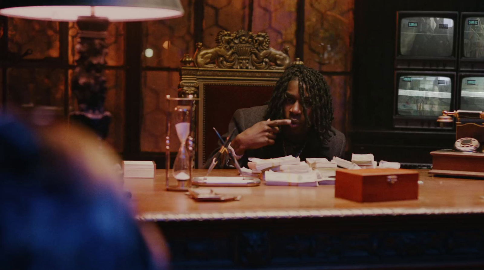 a person sitting at a table with a box of food