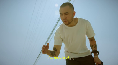 a man with a tattoo on his arm holding a kite