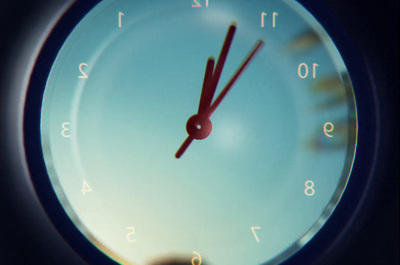 a close up of a clock with a sky background