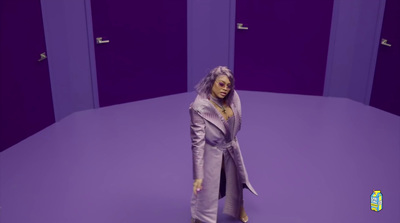 a doll is standing in a purple room