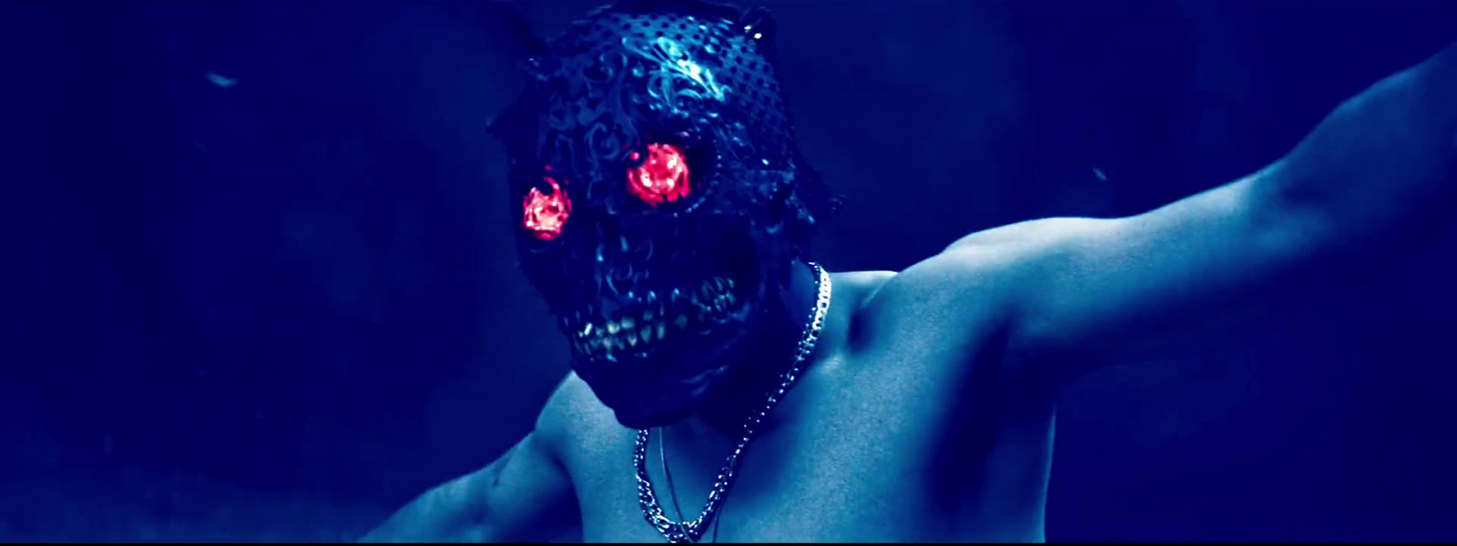 a man wearing a blue mask with red eyes