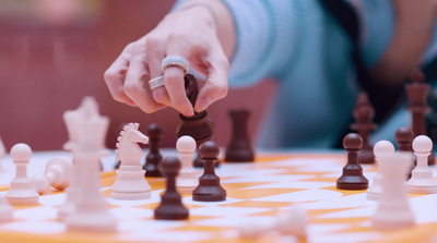 a person playing a game of chess on a table