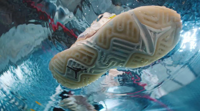 a close up of a pair of shoes in water