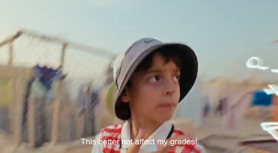 a young boy wearing a hat and looking up