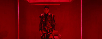 a man standing in a room with a red light