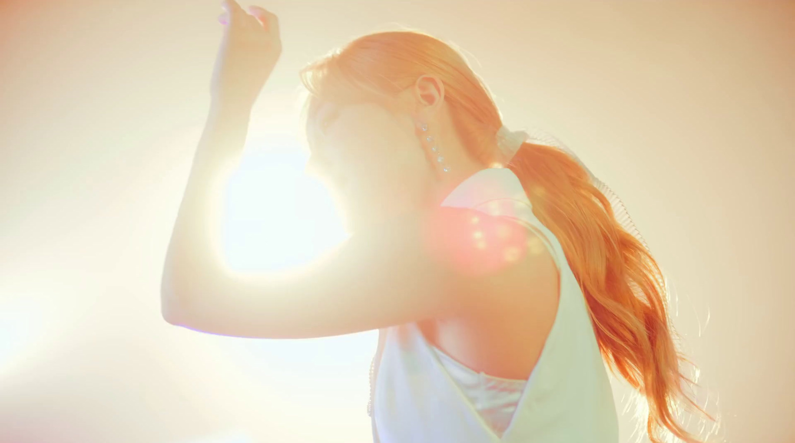 a woman in a white top is holding a cell phone