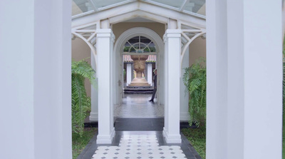 a white and black tiled walkway leading to a building