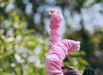 a woman holding a baby up in the air