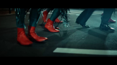 a group of people standing next to each other wearing red shoes