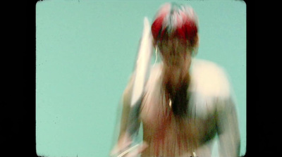 a blurry photo of a person holding a surfboard