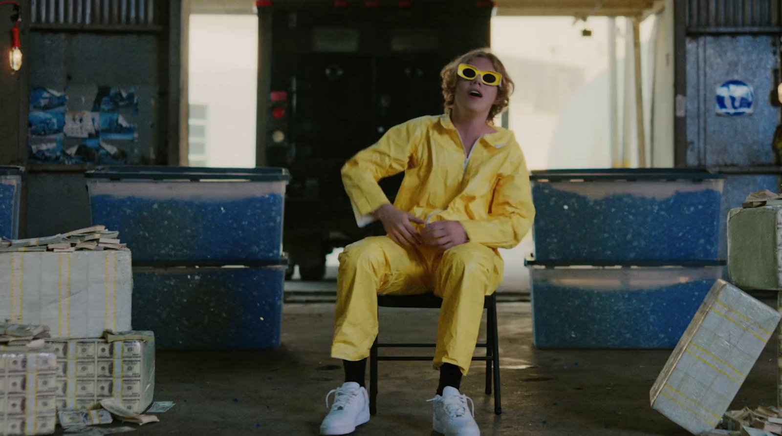 a man in a yellow suit sitting on a chair