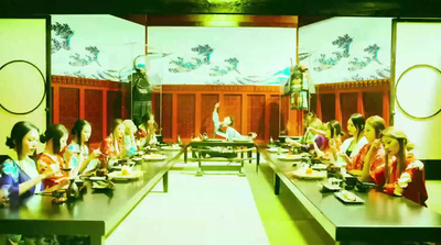 a group of people sitting around a long table