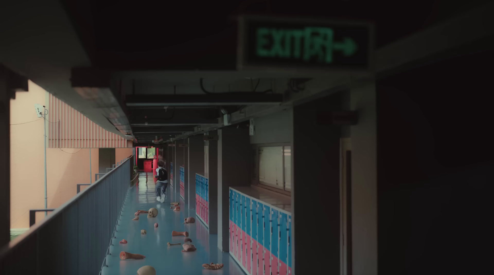 a long hallway with a sign that says exit