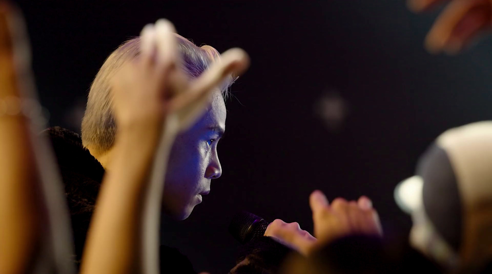 a group of people standing around each other at a concert