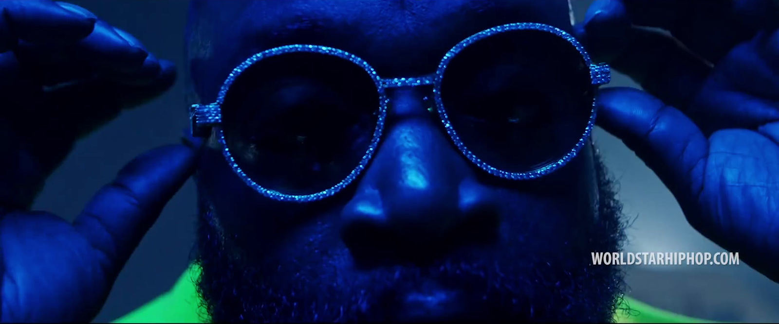 a man with a beard and blue glasses