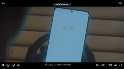 a person holding a cell phone with the number 611 on it