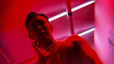 a man standing in a room with a red light