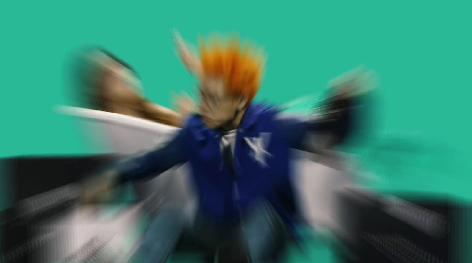 a blurry image of a man with orange hair