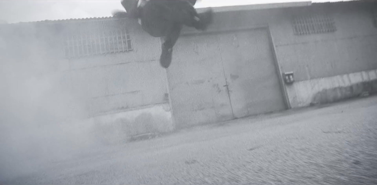 a man riding a skateboard down the side of a wall