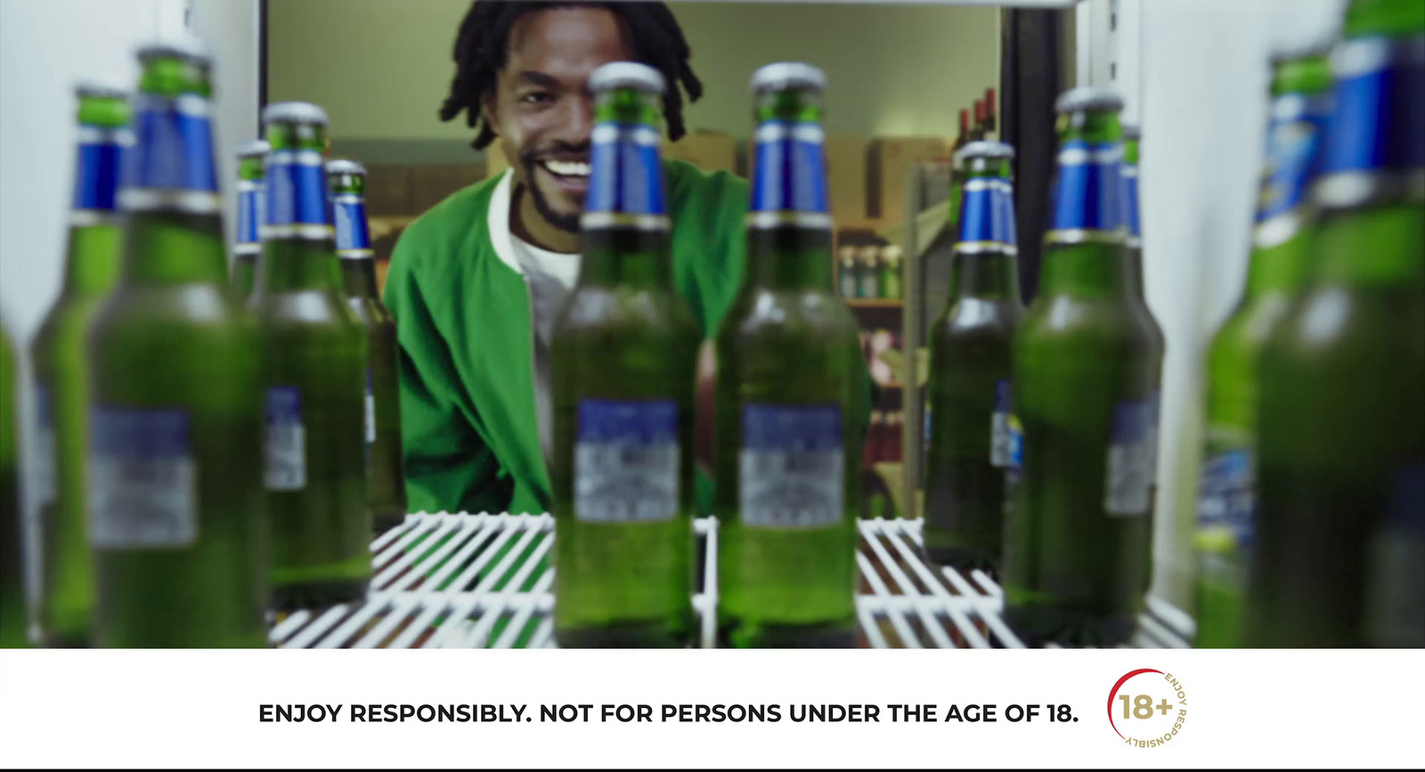 a man is surrounded by bottles of beer