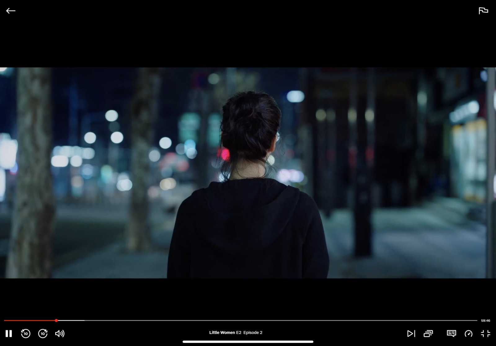 a woman standing on a street at night