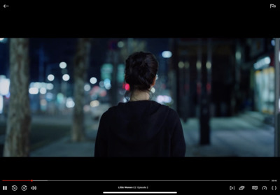 a woman standing on a street at night