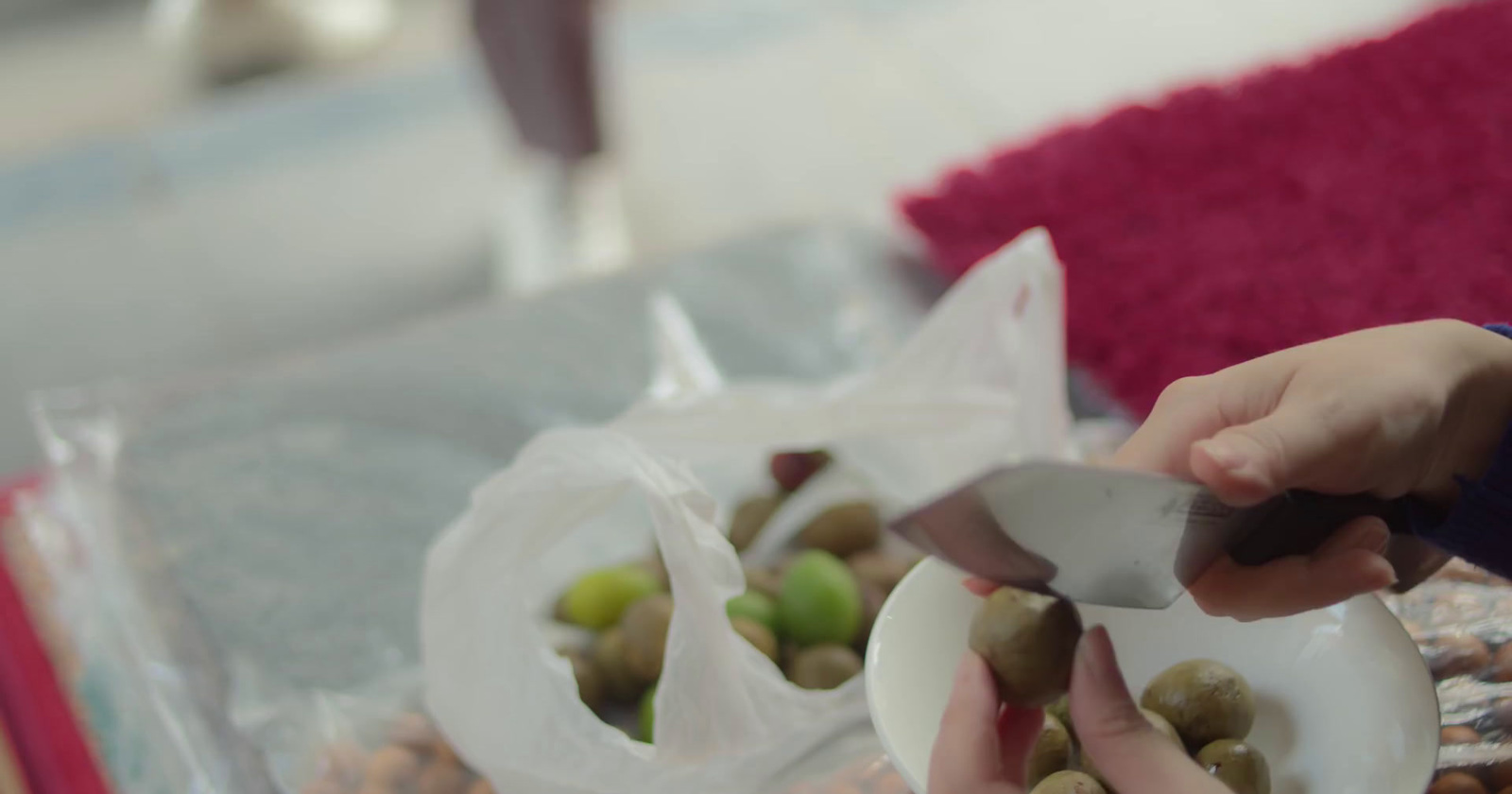 a person cutting up some food on a plate