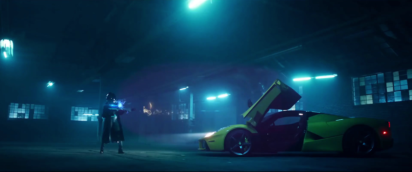 a man standing next to a yellow and red car