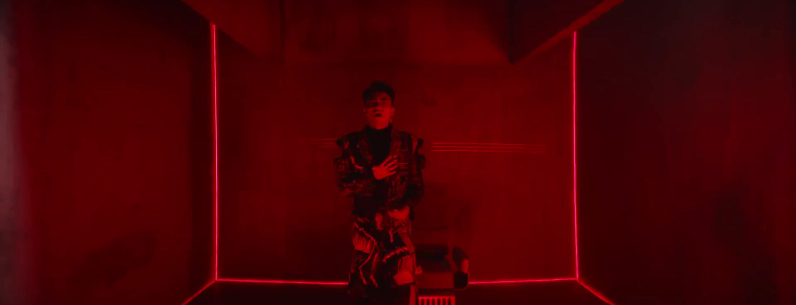 a man standing in a room with red lights