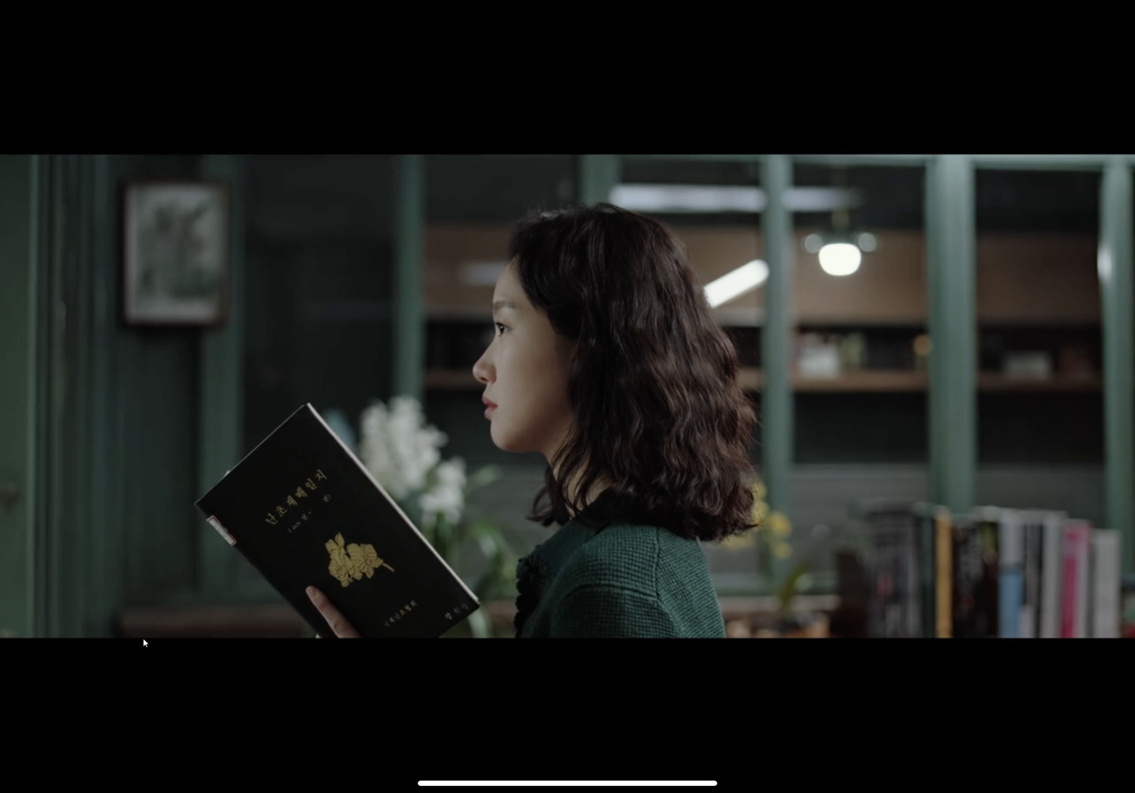 a woman holding a book in a library