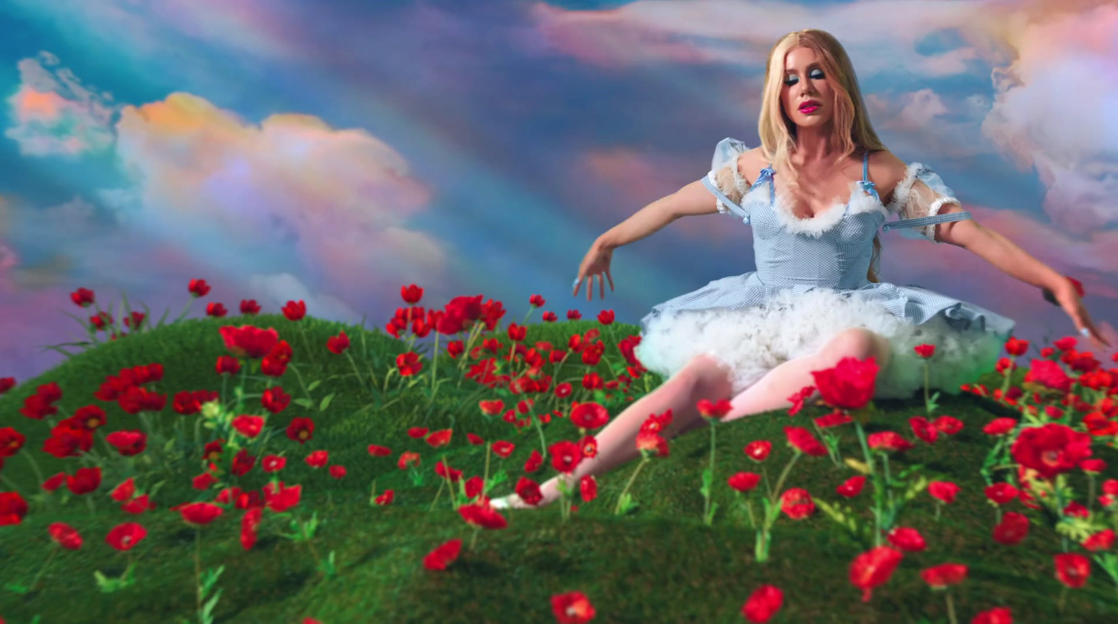 a woman in a white dress sitting in a field of flowers