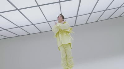 a man in a yellow outfit standing in a room