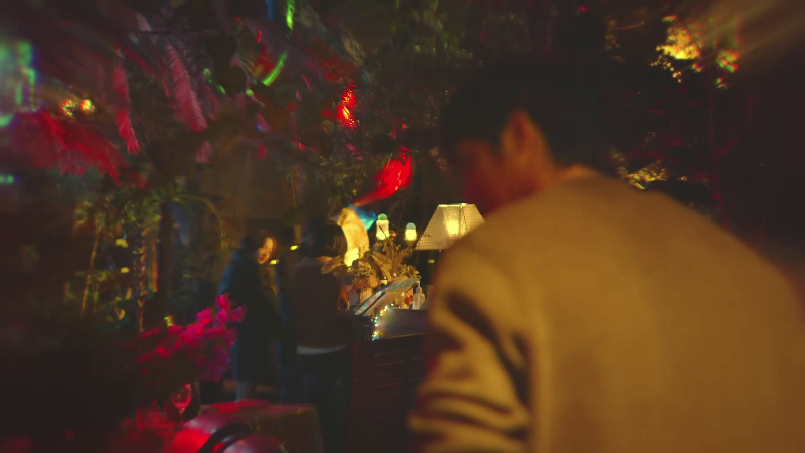 a man standing in front of a christmas tree