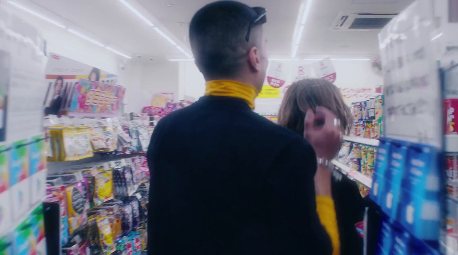 a man and a woman in a store aisle