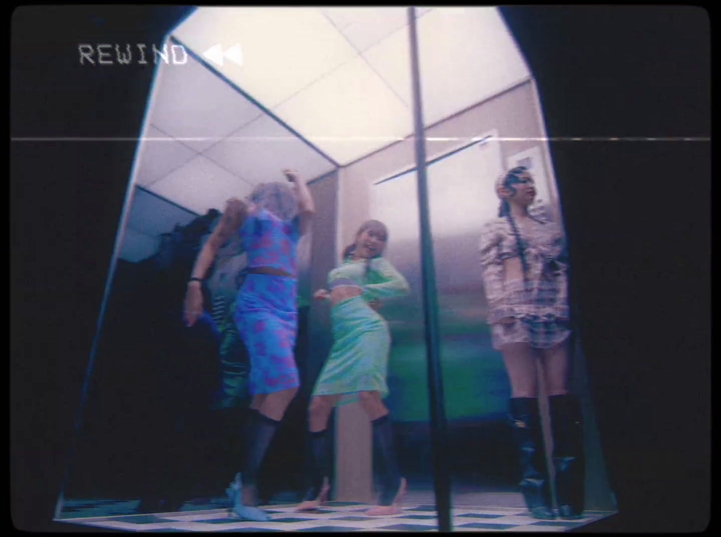 a group of women standing in front of a mirror