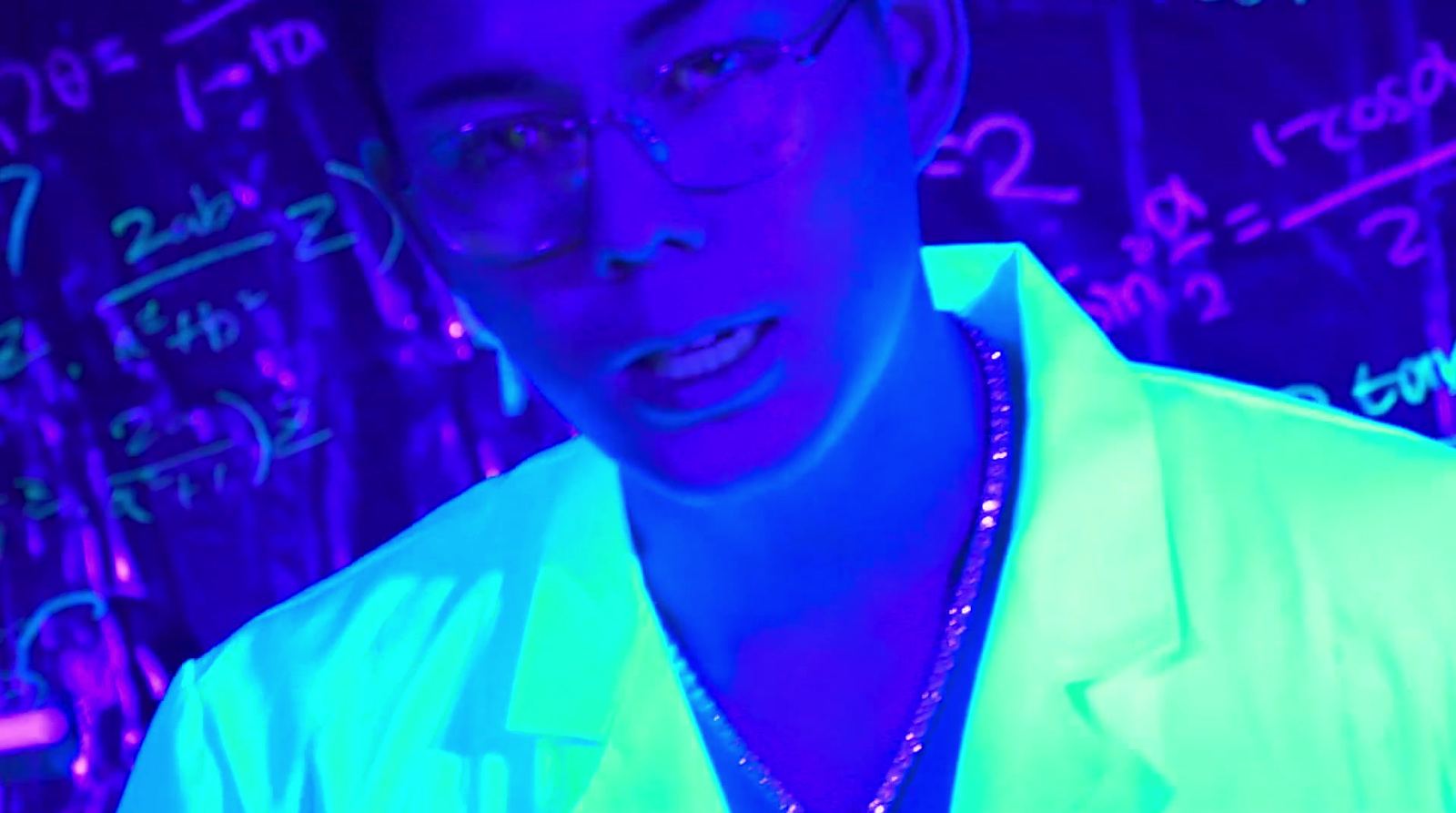 a man wearing glasses and a neon shirt