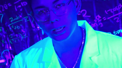 a man wearing glasses and a neon shirt