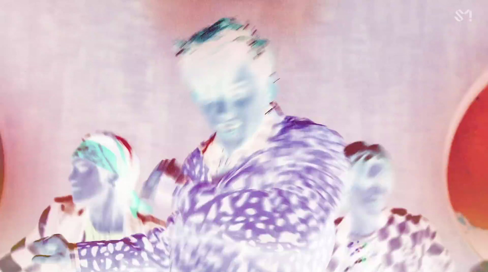 a blurry image of a man and a woman dancing