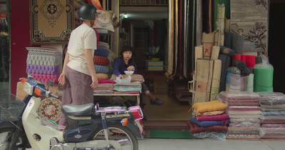 a man standing next to a woman in front of a store