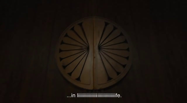 a dark room with a circular wooden door