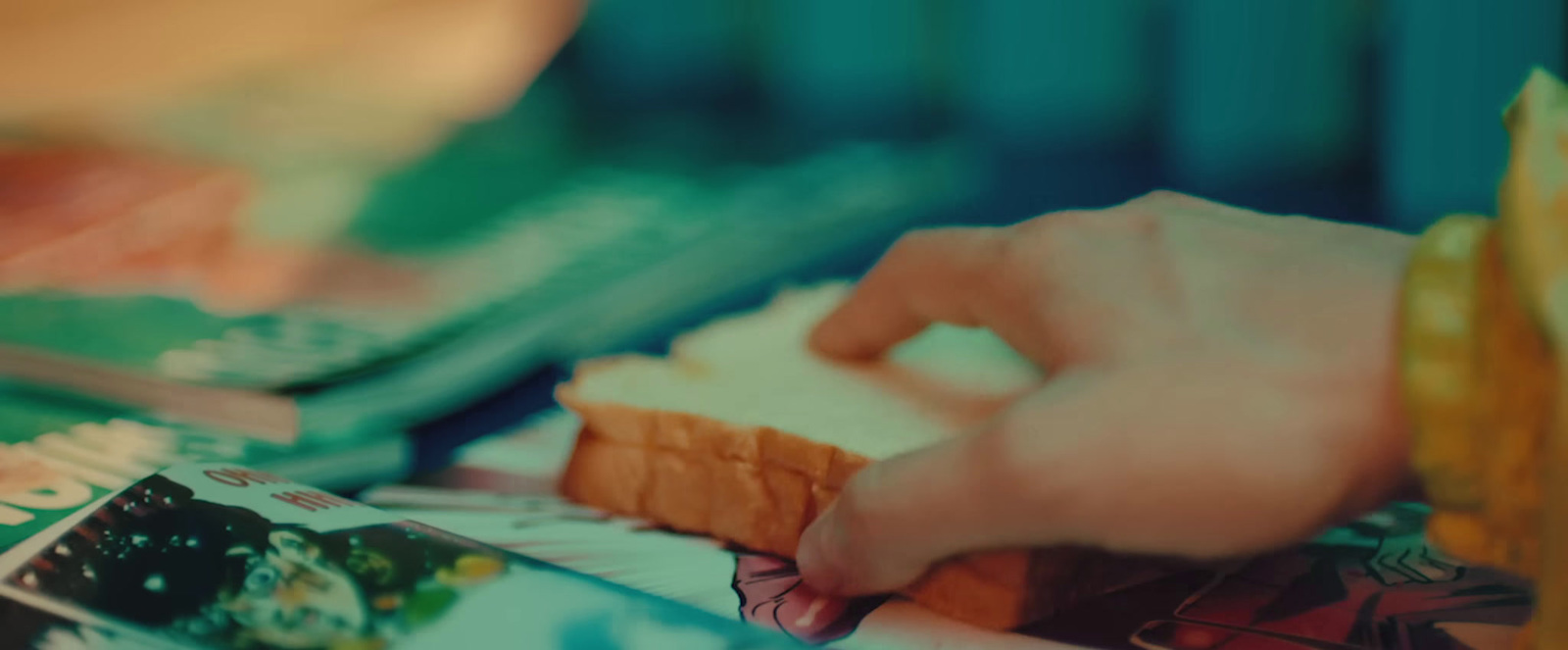 a person holding a piece of bread in their hand