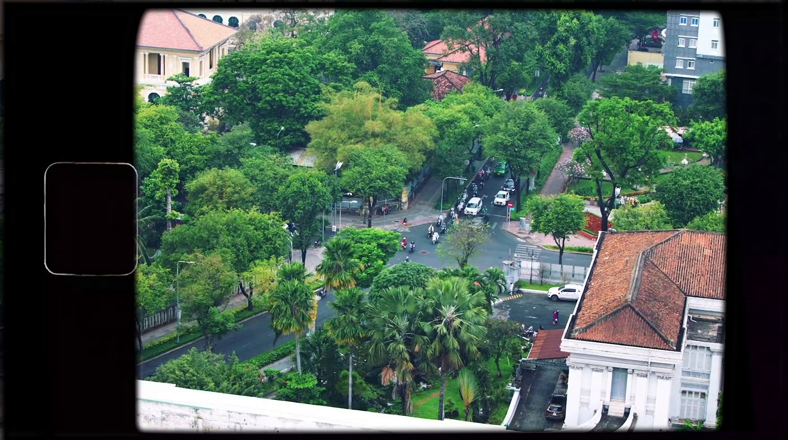 an aerial view of a city street and trees