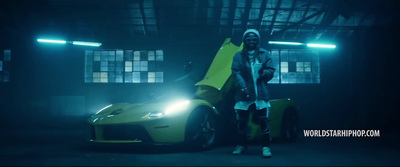 a woman standing next to a yellow sports car