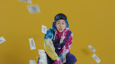 a woman in a colorful scarf throwing money into the air