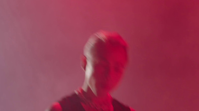 a blurry image of a man in a red shirt