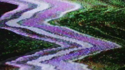 a blurry image of a road in the grass