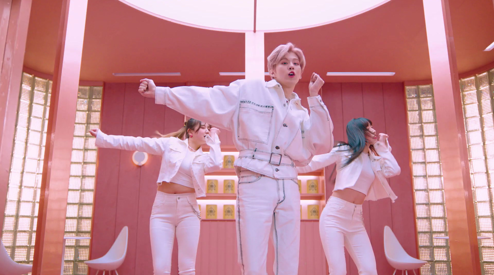 a group of women in white outfits standing in a room