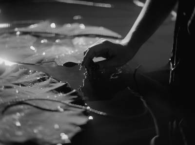 a black and white photo of a person washing their hands