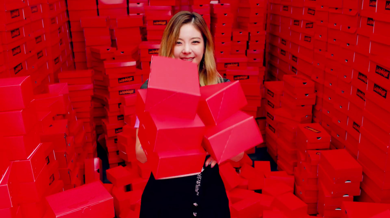 a woman standing in a room full of red boxes